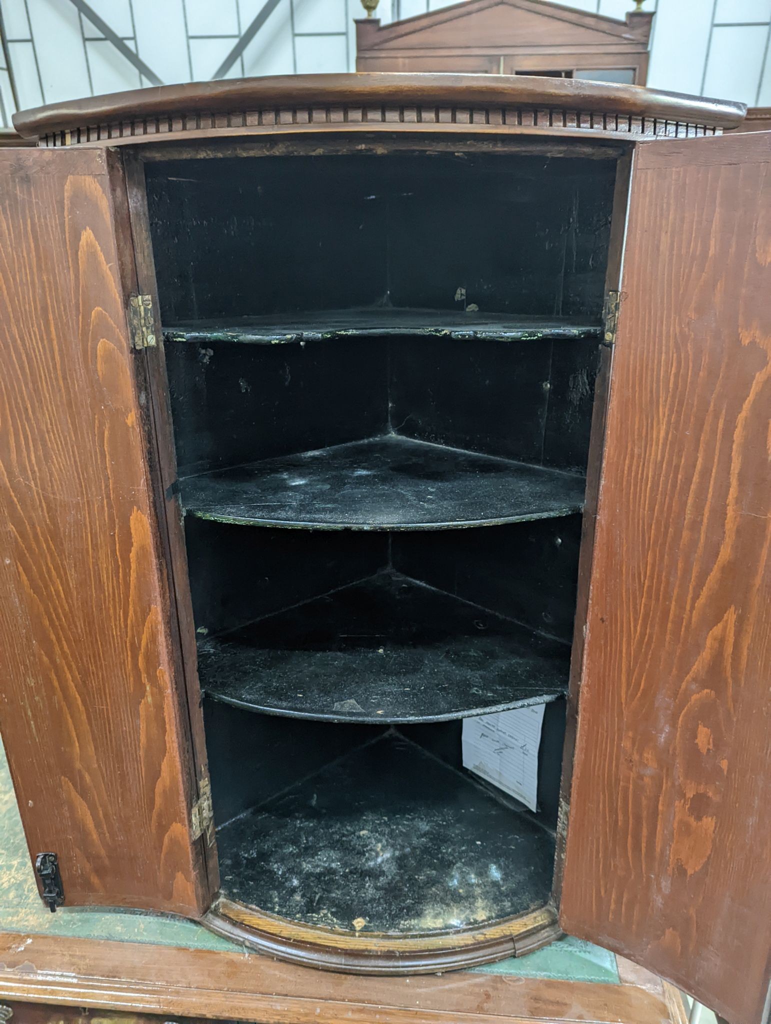 A George III mahogany bowfront hanging corner cabinet, width 70cm, depth 44cm, height 99cm